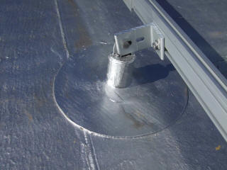 On a flat roof, the standoffs are attached to the roof structure and sealed  before the rails are attached.